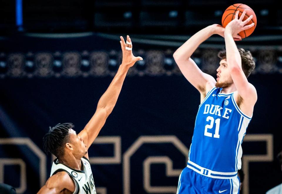 Duke forward Matthew Hurt (21) shoots over defense from Wake Forest forward Ody Oguama (33) on Wednesday, Feb. 17, 2021 in Winston-Salem, N.C.