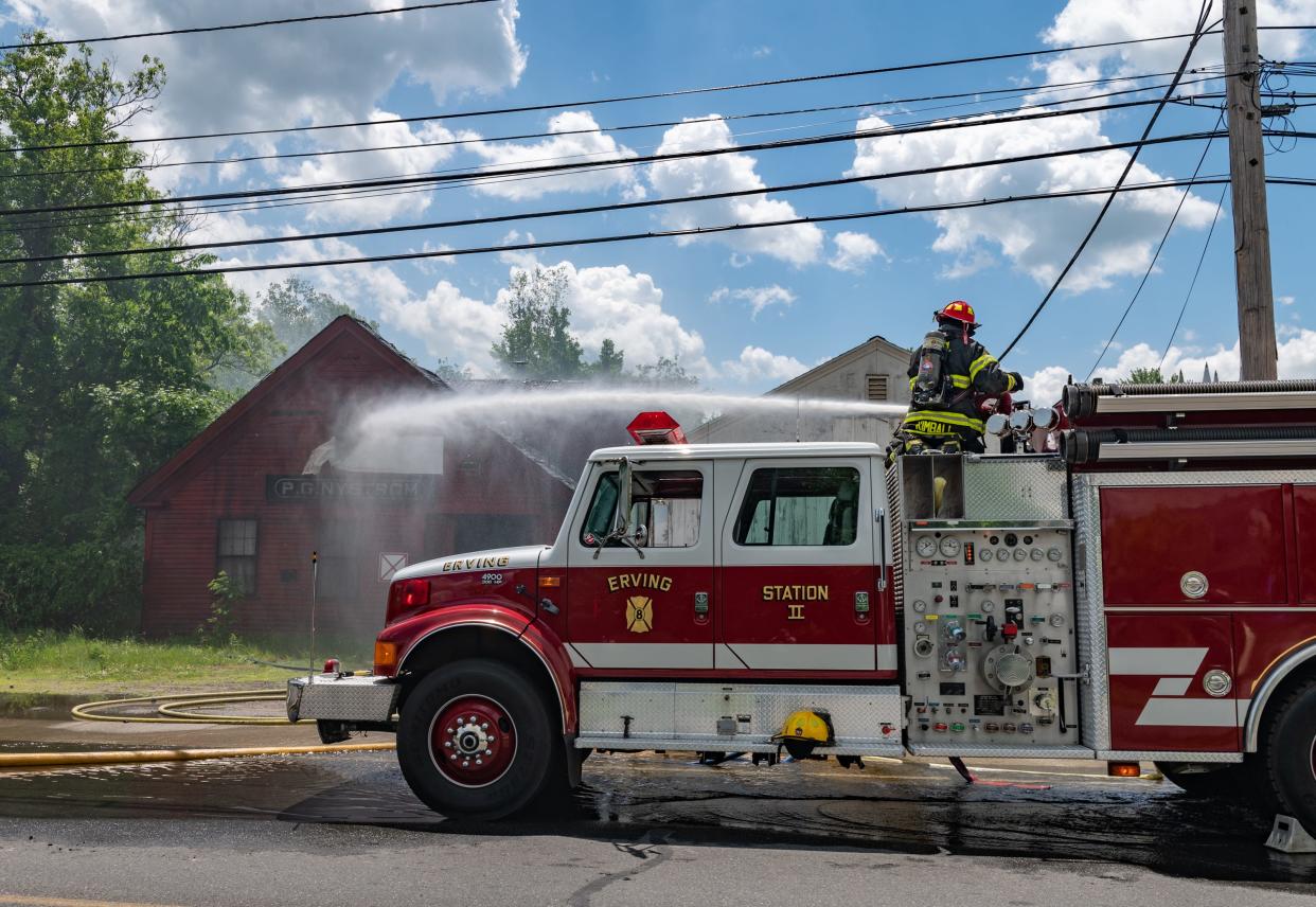 An Erving engine company is the only truck available to fight a fire in a vacant blacksmith shop Saturday on East River Road during a mill fire in Orange.