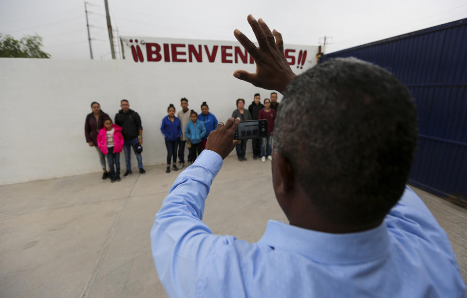 In this Oct. 12, 2019 photo, migrants grouped by families line up for a photo prior to their interviews with U.S. immigration officials, at a migrant shelter in Reynosa, Mexico. In years past, migrants seeking asylum in the United States moved quickly through this violent territory on their way to the U.S., but now due to Trump administration policies, they remain here for weeks and sometimes months as they await their U.S. court dates, often in the hands of gangsters who hold Tamaulipas state in a vice-like grip. (AP Photo/Fernando Llano)