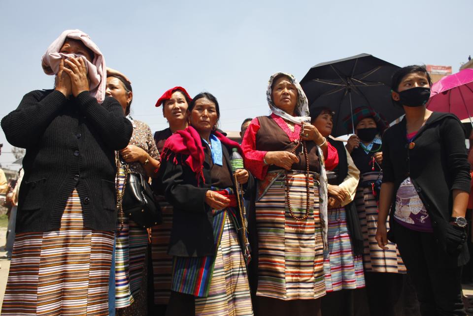 Relatives of Nepalese climbers killed in an avalanche on Mount Everest, wait for the funeral procession to begin in Katmandu, Nepal, Monday, April 21, 2014. Buddhist monks cremated the remains of Sherpa guides who were buried in the deadliest avalanche ever recorded on Mount Everest, a disaster that has prompted calls for a climbing boycott by Nepal's ethnic Sherpa community. The avalanche killed at least 13 Sherpas. Three other Sherpas remain missing and are presumed dead. (AP Photo/Niranjan Shrestha)