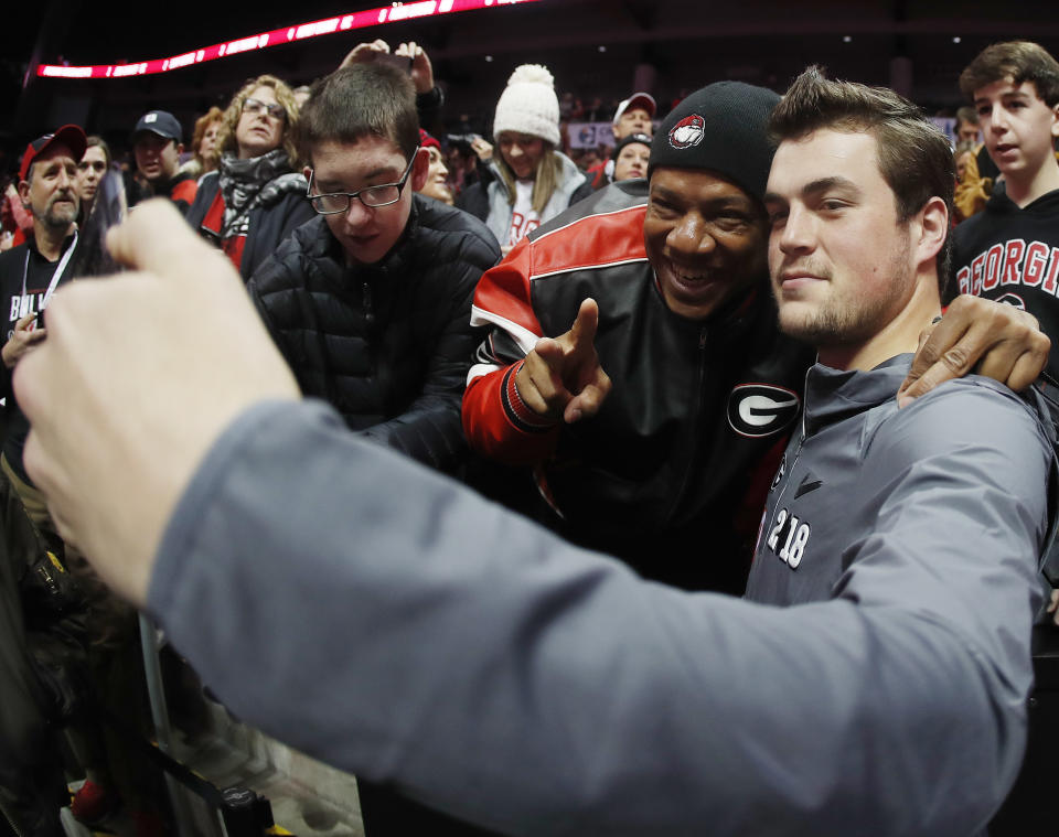 Georgia quarterback Jacob Eason takes a photo with a fan during media day, Saturday, Jan. 6, 2018, in Atlanta. Georgia and Alabama will be playing for the NCAA football national championship on Monday, Jan. 8. (AP Photo/John Bazemore)