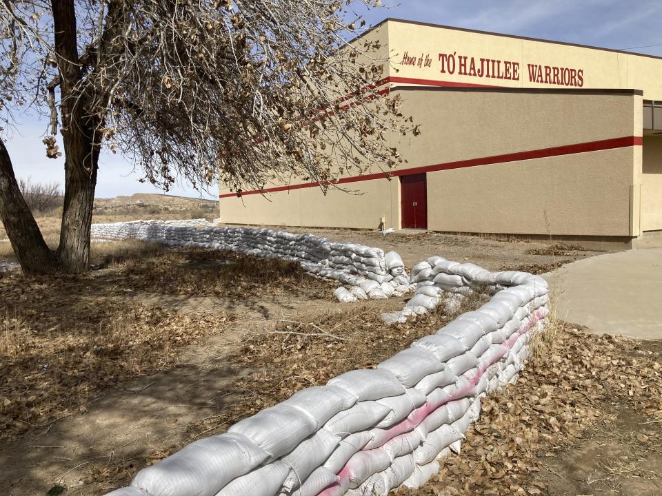 This Feb. 17, 2023 image shows a wall of sandbags protecting the school in the Navajo community of To'Hajiilee, New Mexico. To'Hajiilee Community School is just one of dozens funded by the U.S. Bureau of Indian Education that are in desperate need of repair or replacement. The agency estimates it would cost roughly $6.2 billion to address the needs of those schools in poor condition. (AP Photo/Susan Montoya Bryan)