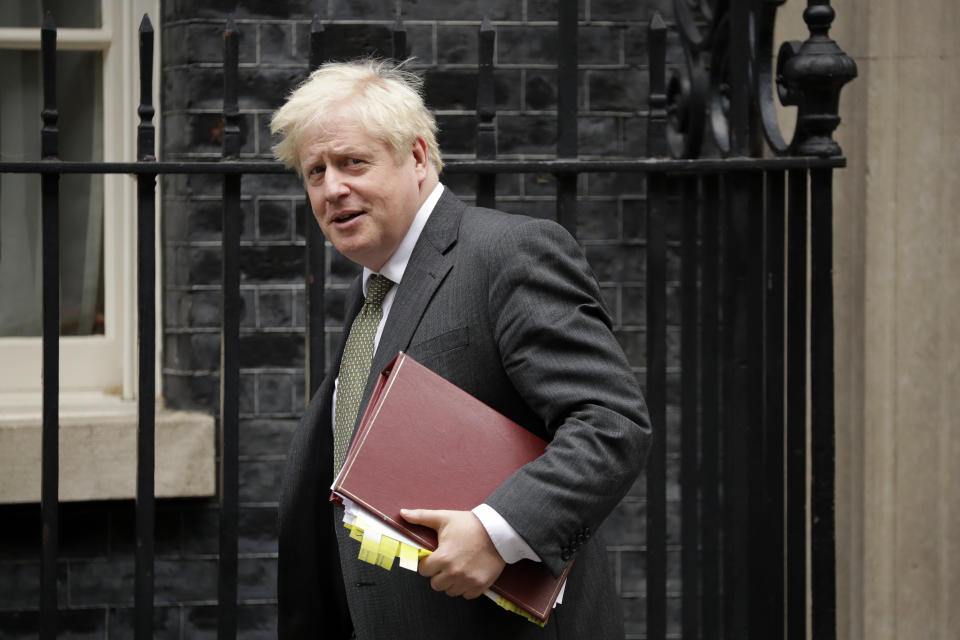 British Prime Minister Boris Johnson leaves 10 Downing Street in London, to attend the weekly Prime Minister's Questions at the Houses of Parliament, in London, Wednesday, Sept. 23, 2020. Johnson appealed Tuesday for resolve and a "spirit of togetherness" through the winter as he unveiled new restrictions on everyday life to suppress a dramatic spike in coronavirus cases. (AP Photo/Matt Dunham)