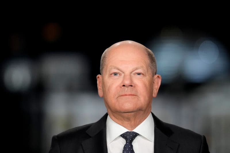 German Chancellor Olaf Scholz poses for a picture on the sidelines of the recording of his New Year's address in the Chancellery. Markus Schreiber/Pool AP/AP