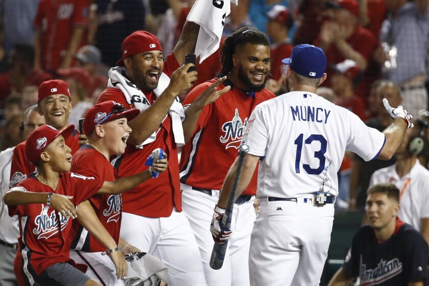 Los Angeles Dodgers Max Muncy (13) is congratulated by his National League teammates.