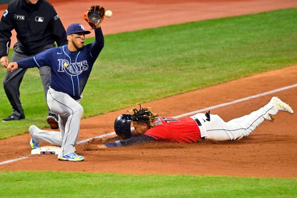 Cleveland's Jose Ramirez slides safety into third ahead of the tag from Tampa Bay's Isaac Paredes.