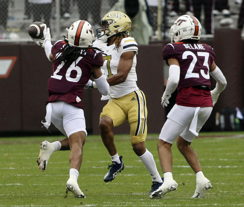 Georgia Tech's Malachi Carter (7) makes one-hand catch in front of Virginia Tech's Jalen Stroman (26) and Mansoor Delane (23) in the first half during an NCAA college football game, Saturday, Nov. 5 2022, in Blacksburg, Va. (Matt Gentry/The Roanoke Times via AP)