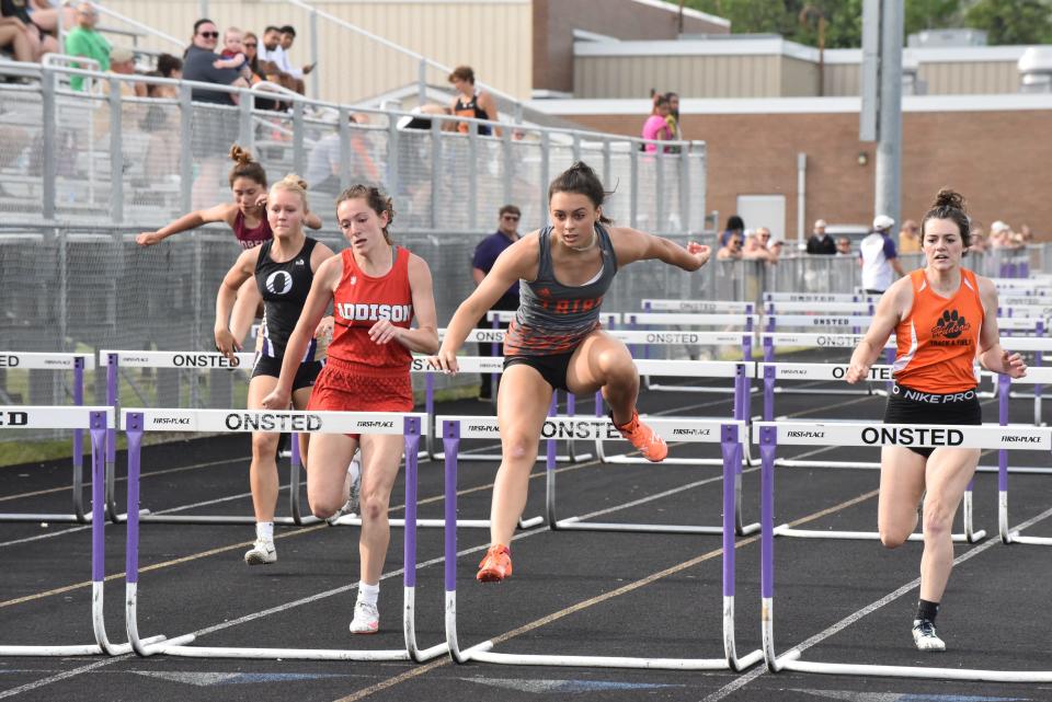 Tecumseh's Brianna Rhodea (middle) and Addison's Molly Brown lead the pack in the high hurdles event at the Lenawee County Track and Field Championships.