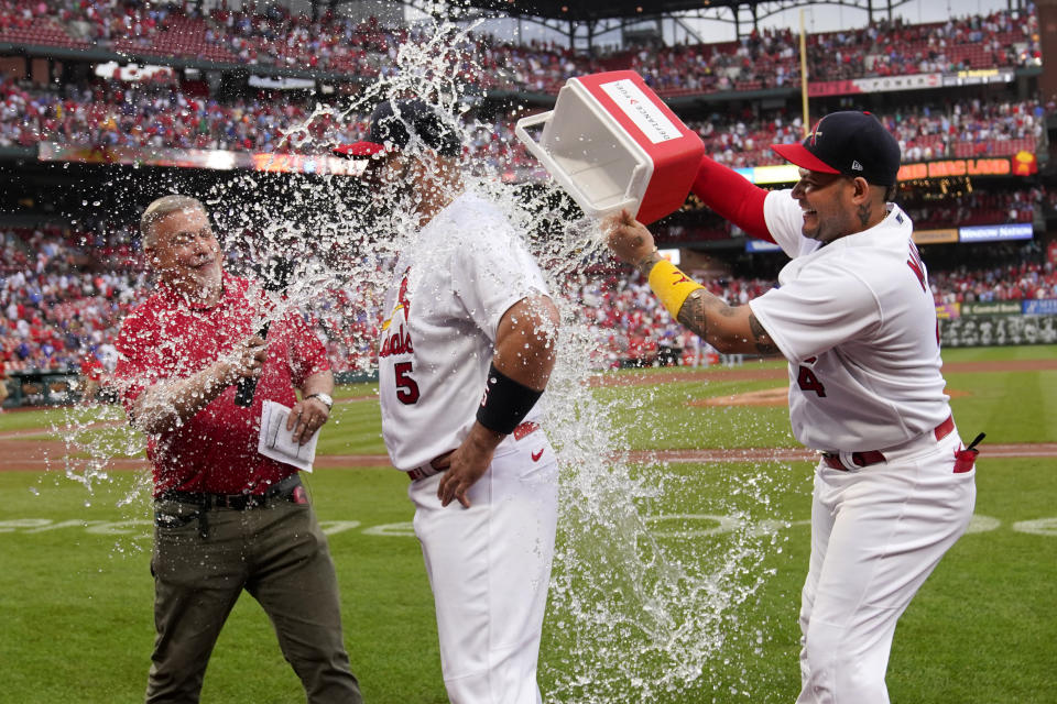 St. Louis Cardinals' Albert Pujols (5) is congratulated by teammate Yadier Molina, right, following a baseball game against the Chicago Cubs Sunday, Sept. 4, 2022, in St. Louis. Pujols hit a two-run home run in the eighth inning to lead the Cardinals to a 2-0 victory. (AP Photo/Jeff Roberson)