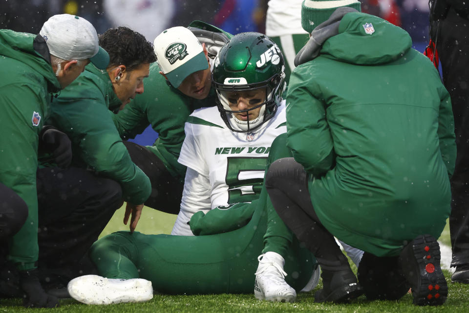 New York Jets quarterback Mike White receives assistance following a play in the first half of an NFL football game against the Buffalo Bills, Sunday, Dec. 11, 2022, in Orchard Park, N.Y. (AP Photo/Jeffrey T. Barnes)