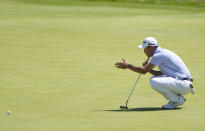 United States' Collin Morikawa looks at the line of his putt on the 18th green during the second round of the British Open Golf Championship at Royal St George's golf course Sandwich, England, Friday, July 16, 2021. (AP Photo/Alastair Grant)