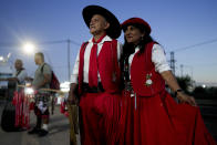 Ruben Barreto and Susana Ponce arrive at the sanctuary of Argentina's most renowned folk Saint "Gauchito" Gil to commemorate his Jan. 8 death, in Mercedes Corrientes, Argentina, Saturday, Jan. 6, 2024. (AP Photo/Natacha Pisarenko)