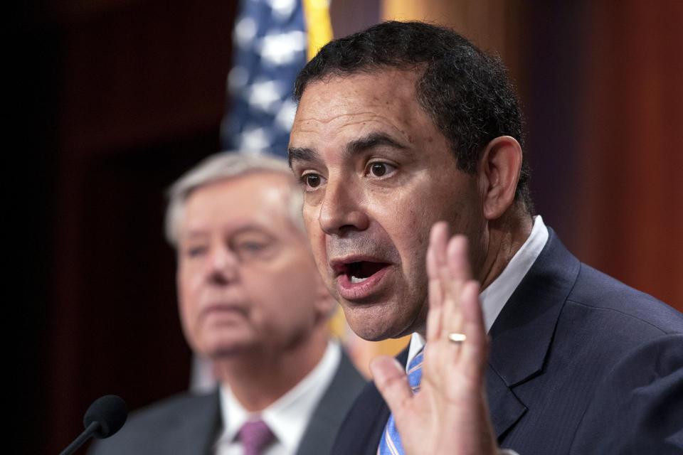 FILE - Rep. Henry Cuellar, D-Texas, with Sen. Lindsey Graham, R-S.C., speaks about the United States-Mexico border during a news conference at the Capitol in Washington, July 30, 2021. The 2022 midterm election season opens Tuesday, March 1, in Texas. Cuellar is facing a progressive challenger just weeks after FBI agents raided his home. (AP Photo/Manuel Balce Ceneta, File)