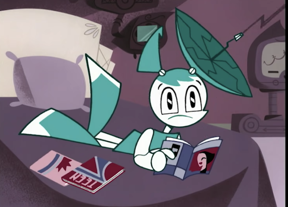 Jenny, the teenage robot, lying on bed reading magazines