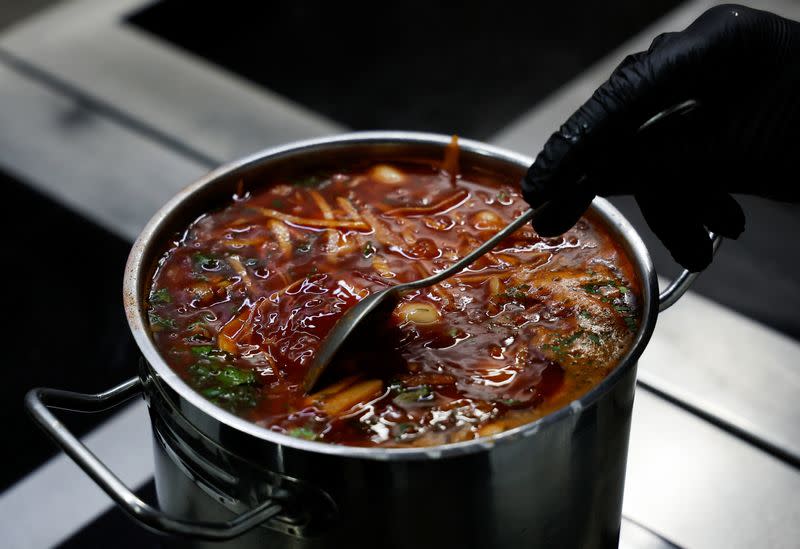 Ukrainian chef Marshal cooks borshch at a traditional cuisine restaurant in Kyiv