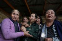 Mourners attend a funeral following recent shelling in Garayusifli