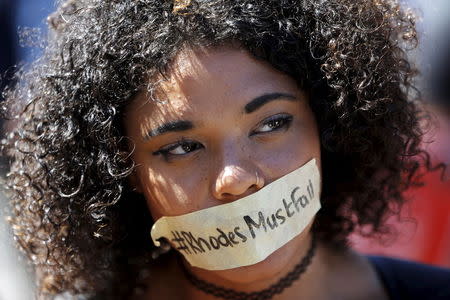 A student wears a sticker calling for the removal of a statue of Cecil John Rhodes from the campus of the University of Cape Town March 20, 2015. REUTERS/Mike Hutchings