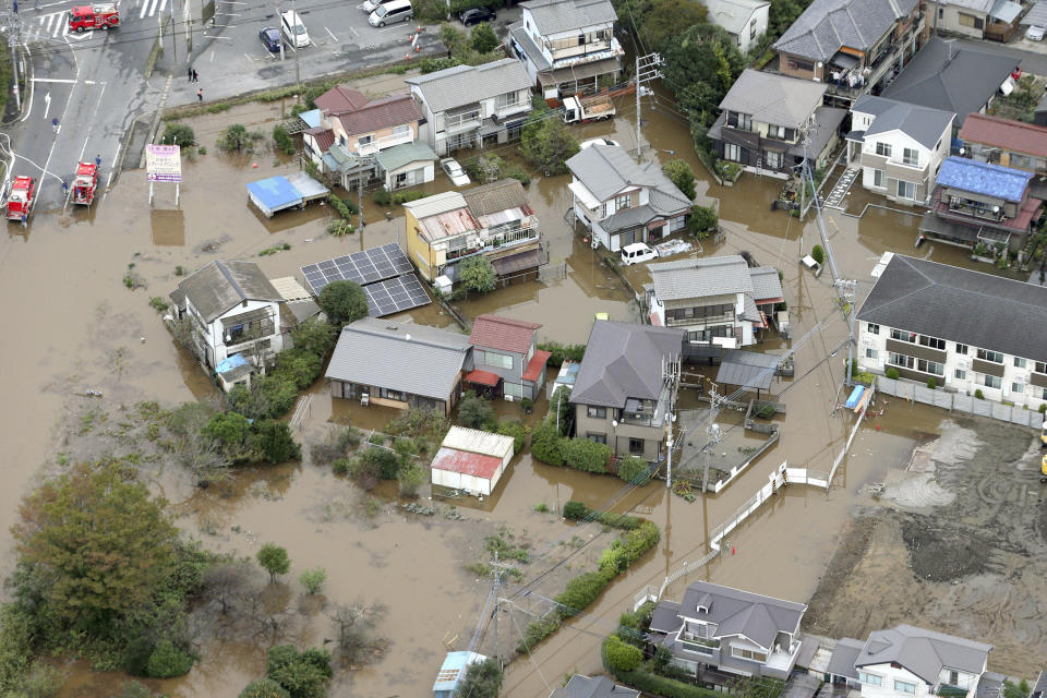 A residential area is flooded after torrential rain in Sakura city, Chiba prefecture, east of Tokyo Saturday, Oct. 26, 2019. Torrential rain that caused flooding and mudslides in towns east of Tokyo added damage in areas still recovering from recent typhoons. (Kyodo News via AP)