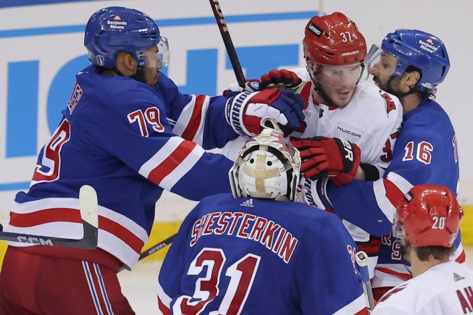 May 7, 2024; New York, New York, USA; New York Rangers defenseman K’Andre Miller (79) and center Vincent Trocheck (16) separate Carolina Hurricanes right wing Andrei Svechnikov (37) from Rangers goaltender Igor Shesterkin (31) during the second overtime of game two of the second round of the 2024 Stanley Cup Playoffs at Madison Square Garden. Mandatory Credit: Brad Penner-USA TODAY Sports