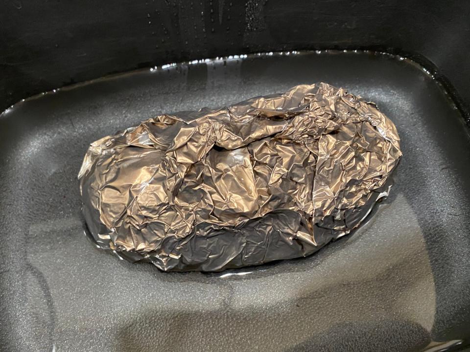 baked potato wrapped in foil in a slow cooker