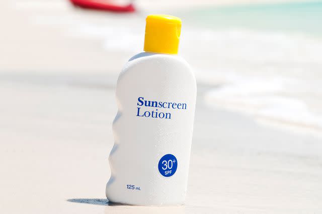 <p>George Clerk/Getty</p> Stock image of a bottle of sunscreen.