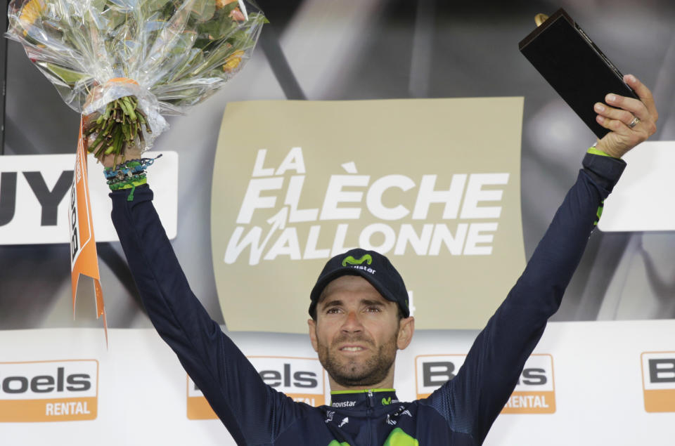 Spain's Alejandro Valverde, center, of the Movistar team celebrates on the podium after he won the Belgian cycling classic Walloon Arrow/Fleche Wallonne, in Huy, Belgium, Wednesday, April 23, 2014. Ireland's Daniel Martin, left, of the Garmin team came second, Poland's Michal Kwiatkowski, right, of the Omega Pharma team was third. (AP Photo/Yves Logghe)