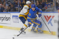 St. Louis Blues' Robert Thomas, right, is checked off the puck by Nashville Predators' Dante Fabbro during the second period of an NHL hockey game Saturday, Feb. 15, 2020, in St. Louis. (AP Photo/Billy Hurst)