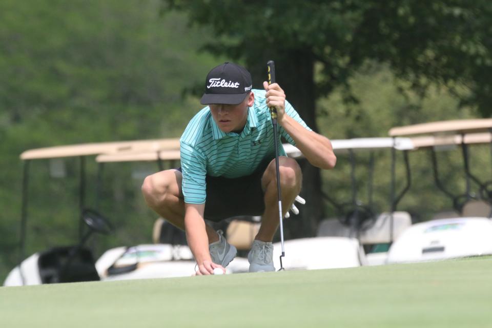 Clear Fork's Nate Lind lines up his ball during Day 1 of the Richland County Junior Golf Tournament on Monday morning.