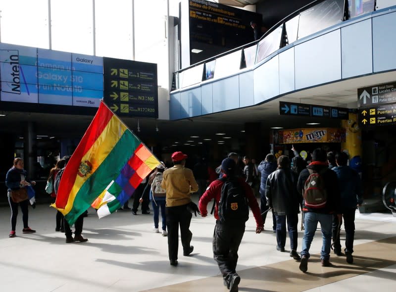 Supporters of Bolivia's President Evo Morales protest against Luis Fernando Camacho, President of Civic Committee of Santa Cruz, at the El Alto airport, on the outskirts of La Paz