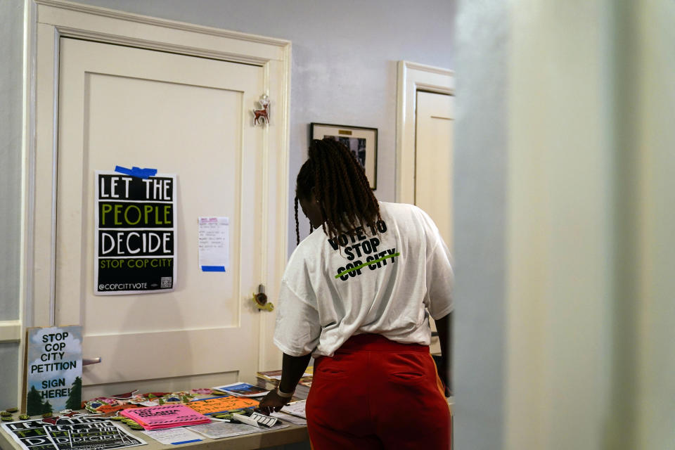 Volunteer Rojauna McPherson looks at a table full of pamphlets after being trained as a new volunteer at one of the "Stop Cop City" movement headquarters, Thursday, July 20, 2023 in Atlanta. Activists with the Stop Cop City Vote Coalition are trying to get the signatures of more than 70,000 Atlanta residents by Aug. 14 to force a referendum allowing voters to decide the fate of a proposed police and firefighter training center. (AP Photo/Brynn Anderson)