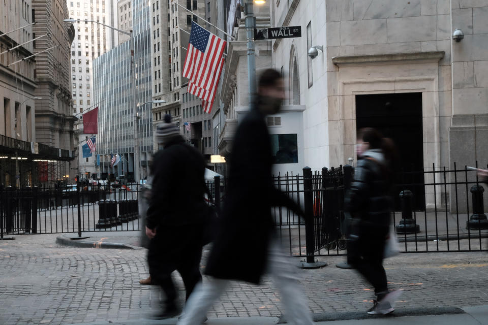 NEW YORK, NEW YORK - JANUARY 26: People walk by the New York Stock Exchange (NYSE) in the Financial District on January 26, 2022 in New York City. The Dow Jones Industrial Average was up nearly 200 points in morning trading following days of volatility in global markets.  (Photo by Spencer Platt/Getty Images)