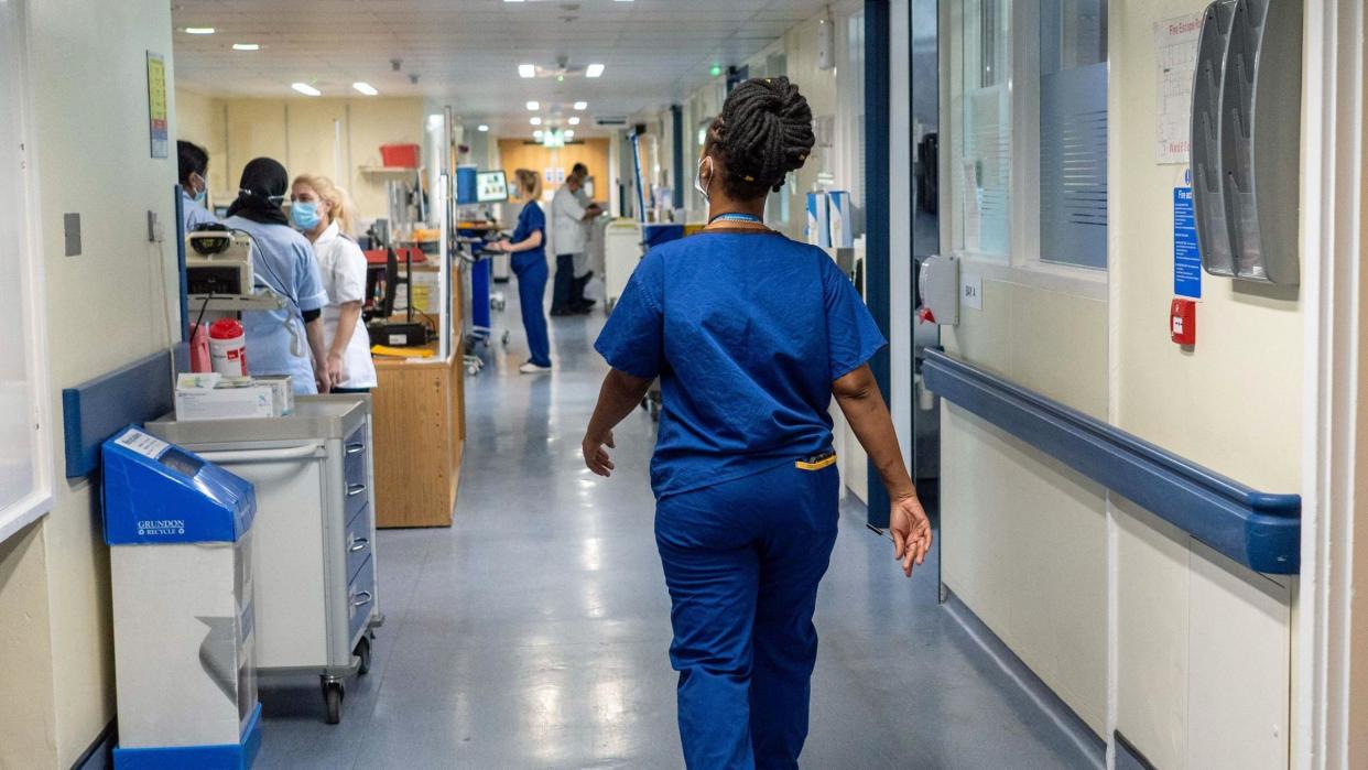 Medical worker walking down a hospital corridor