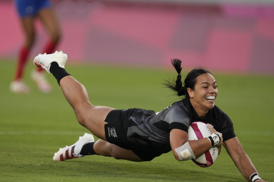 New Zealand's Stacey Fluhler dives to score a try, in the women's rugby gold medal match between New Zealand and France at the 2020 Summer Olympics, Saturday, July 31, 2021 in Tokyo, Japan. (AP Photo/Shuji Kajiyama)