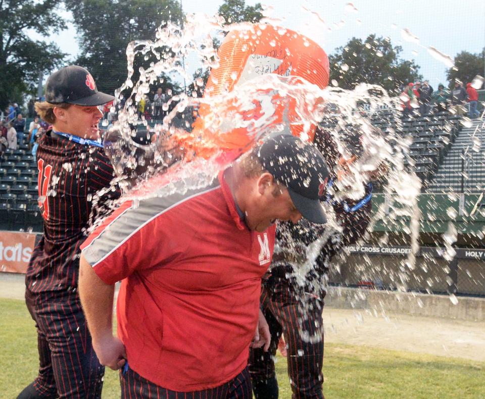 Milton head coach Brendan Morrissey wears a cooler of water to celebrate the team's victory over King Philip in the MIAA Division 2 state championship game at Fitton Field in Worcester on Saturday, June 18, 2022.