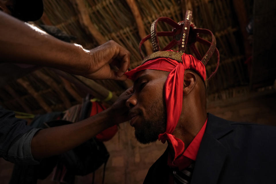 Vandeli Matos is crowned as Emperor of the Holy Spirit during the culmination of the week-long pilgrimage and celebration for the patron saint "Nossa Senhora da Abadia" or Our Lady of Abadia, in the rural area of Cavalcante in Goias state, Brazil, Sunday, Aug. 14, 2022. (AP Photo/Eraldo Peres)