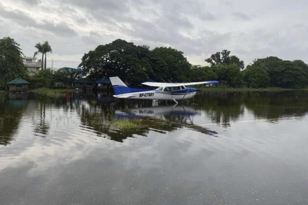 In this photo provided by the Civil Aviation Authority of the Philippines, a plane lies on a flooded airport caused by powerful Typhoon Krathon at San Fernando, La Union province, northern Philippines Monday, Sept. 30, 2024. (Civil Aviation Authority of the Philippines via AP)