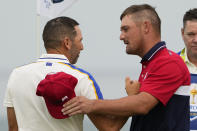 Team USA's Bryson DeChambeau shakes hands with Team Europe's Sergio Garcia after winning on the 16th hole during a Ryder Cup singles match at the Whistling Straits Golf Course Sunday, Sept. 26, 2021, in Sheboygan, Wis. (AP Photo/Jeff Roberson)