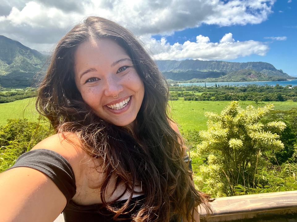 Selfie of the writer in front of Hawaiian mountain