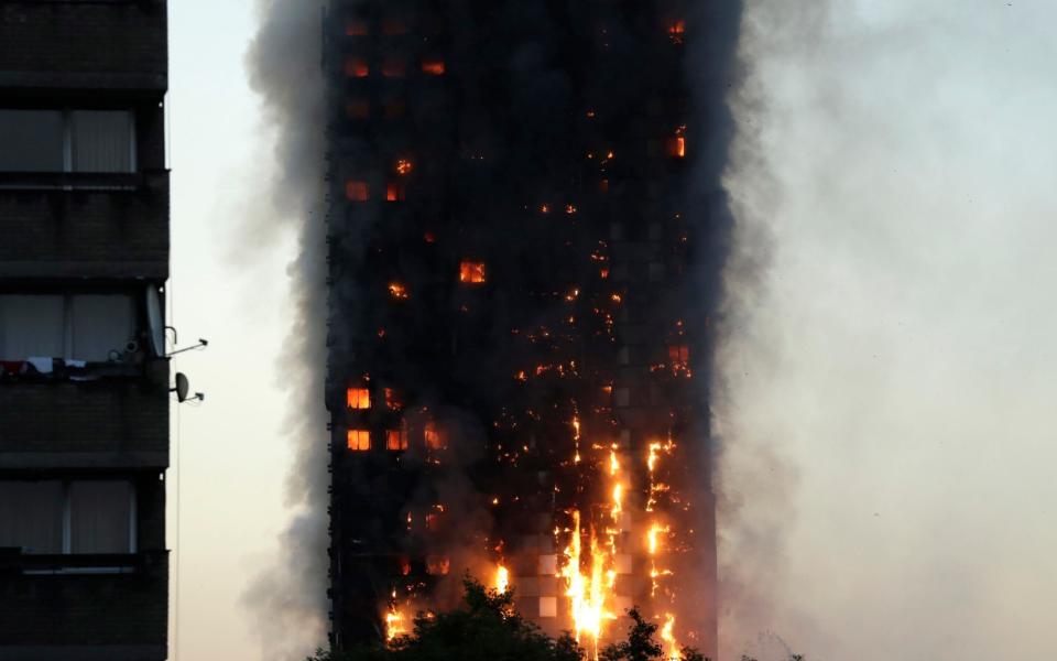 Dawn is breaking as the fire continues to rage - Credit: AP