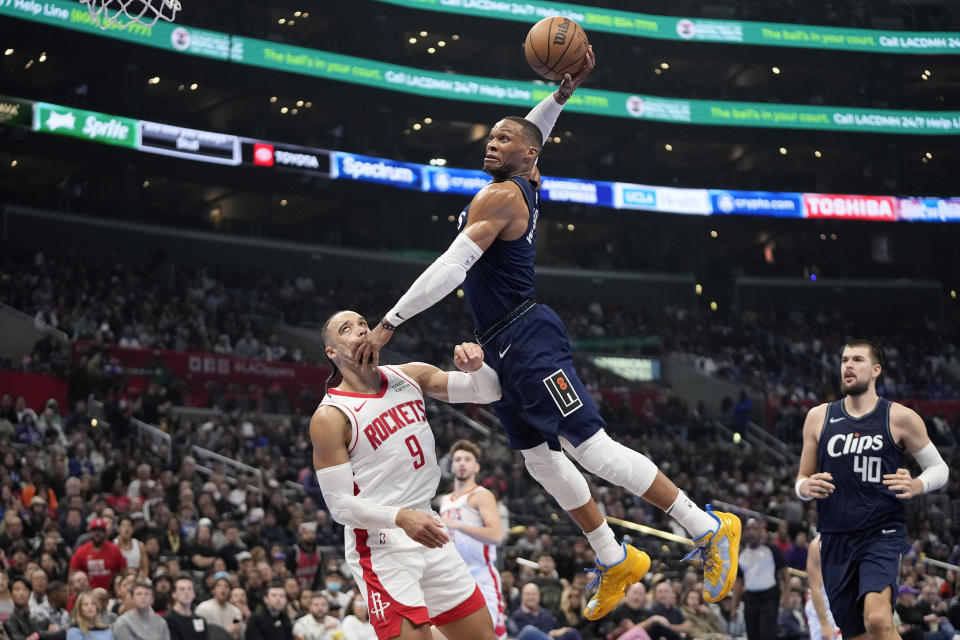 Los Angeles Clippers guard Russell Westbrook, center, attempts a dunk as he hits Houston Rockets forward Dillon Brooks, left, in the face as center Ivica Zubac watches during the first half of an NBA basketball In-Season Tournament game Friday, Nov. 17, 2023, in Los Angeles. Westbrook did not complete the dunk and Brooks was called for a foul on the play. (AP Photo/Mark J. Terrill)