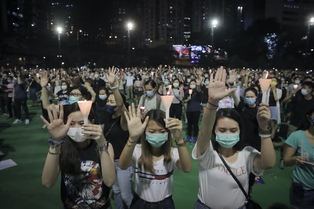 Participants gesture with five fingers, signifying the “Five demands – not one less” during a vigil for the victims of the 1989 Tiananmen Square Massacre(Kin Cheung/AP)