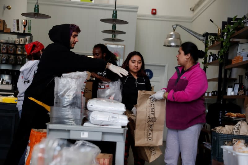 Employees laid off from Farley’s East cafe, that closed due to the financial crisis caused by the coronavirus disease (COVID-19), collect food items at the cafe in Oakland, California