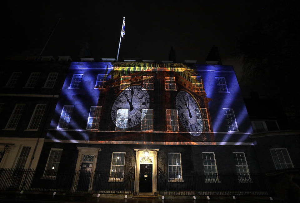 An image of the clock face of 'Big Ben' is projected onto the exterior of 10 Downing street, the residence of the British Prime Minister, in London as Britain left the European Union, Friday, Jan. 31, 2020. With little fuss and not much fanfare, Britain left the European Union on Friday after 47 years of membership, taking a leap into the unknown in a historic blow to the bloc. (AP Photo/Kirsty Wigglesworth)