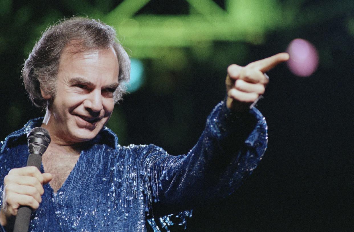 Neil Diamond gestures during a performance at New York's Madison Square Garden, July 24, 1986. 