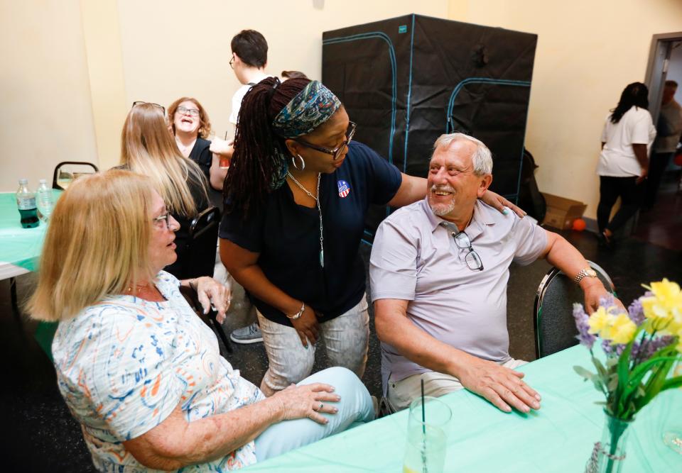 At a watch party Tuesday, Springfield school board incumbent Shurita Thomas-Tate spoke with retired teachers Bruce and Pat Renner. Bruce Renner served on the school board for 27 years.