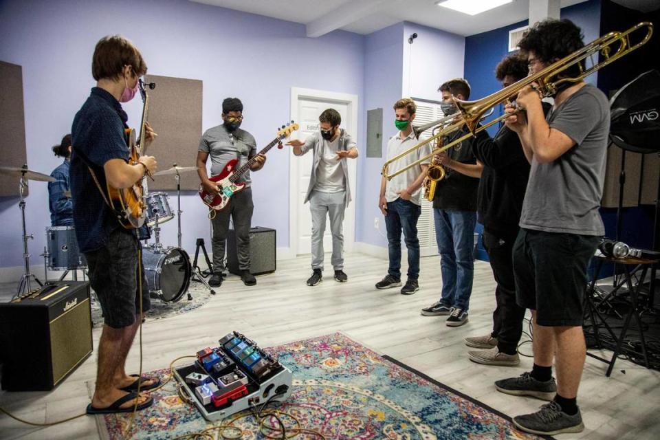 Young Musicians Unite Chief Operating Officer Zachary Larmer, fourth from left, attends a rehearsal of Jazz Collective, a jazz ensemble program at the Wynwood School of Music in Miami. The student musicians come from Young Musicians Unite, a Miami nonprofit.