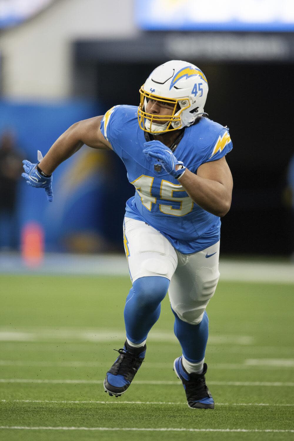 Chargers linebacker Tuli Tuipulotu chases after a play against the Kansas City Chiefs in January.