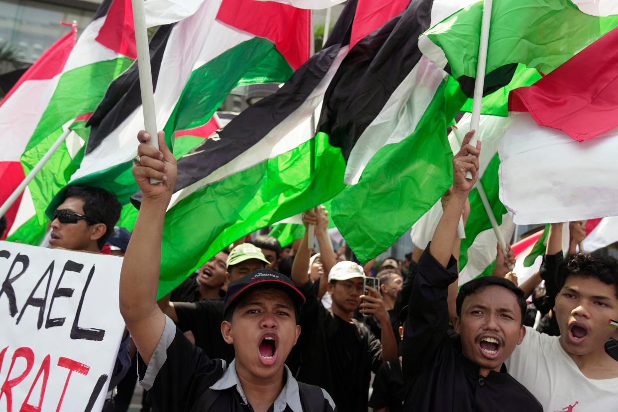 Protesters shout slogans as they wave Palestinian flags during a rally in Jakarta, Indonesia (Copyright 2023 The Associated Press. All rights reserved.)