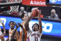 Texas Tech's Kyler Edwards (11) is fouled by Texas' Brock Cunningham (30) during the first half of an NCAA college basketball game in Lubbock, Texas, Saturday, Feb. 27, 2021. (AP Photo/Justin Rex)