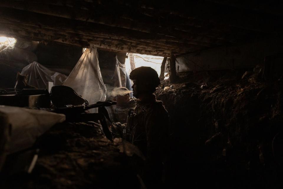 A Ukrainian serviceman with a callsign "Poltava" (44) of the 65th Mechanized Brigade smokes in the trench built by Russian forces, and that was captured by the Ukrainian army, near the front line village of Robotyne, Zaporizhzhia Oblast, on Oct. 1, 2023. (Roman Pilipey/AFP via Getty Images)